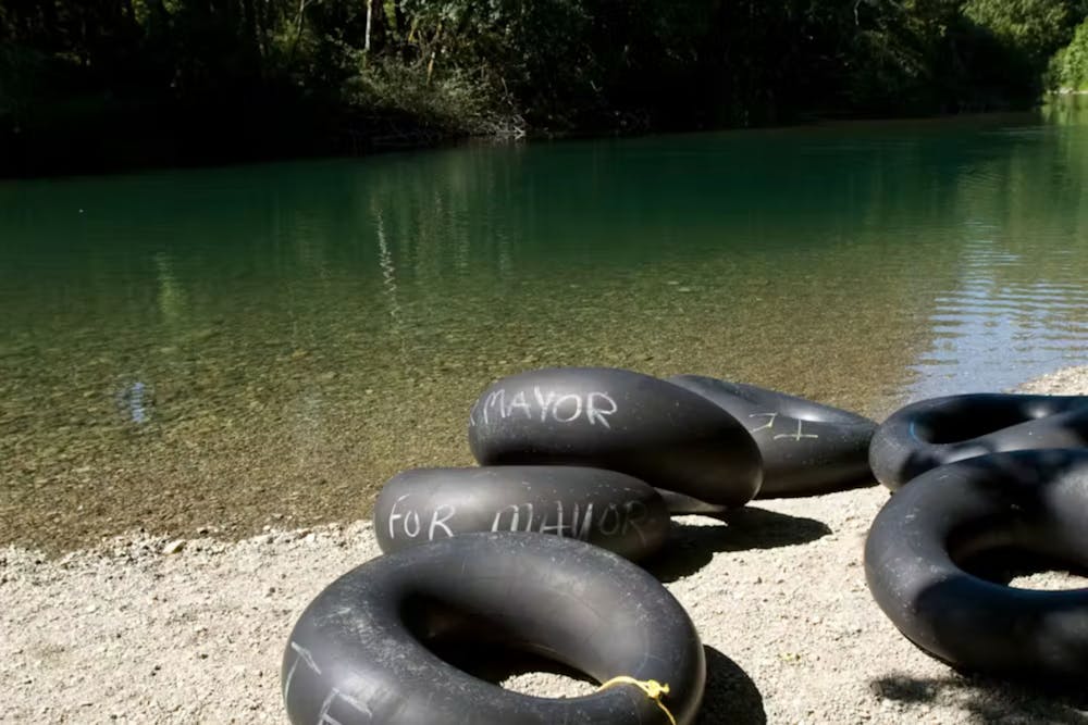 black river tubes sit on a river bank