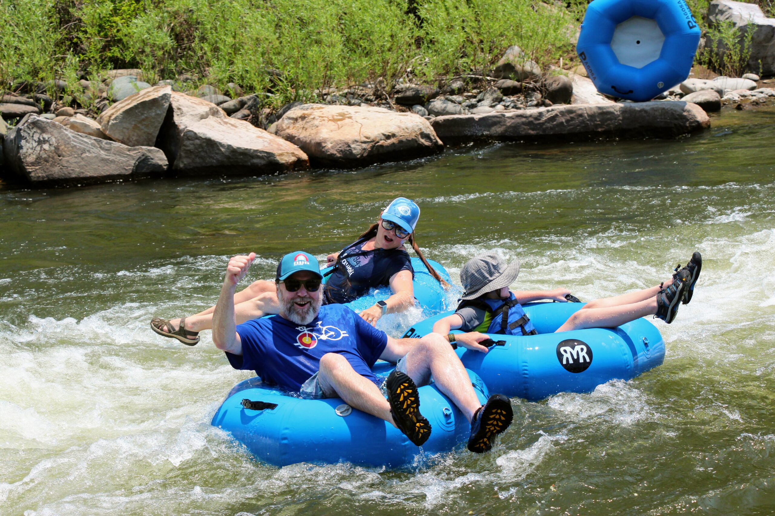 three people float on tubes in pagosa springs