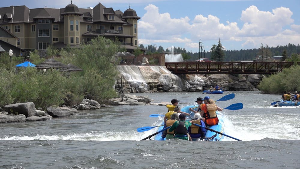 a blue boat full of people floats through Pagosa Springs