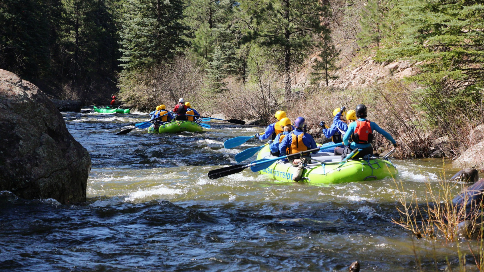 a group of people riding on a raft in a body of water