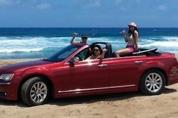 Red convertible on the beach