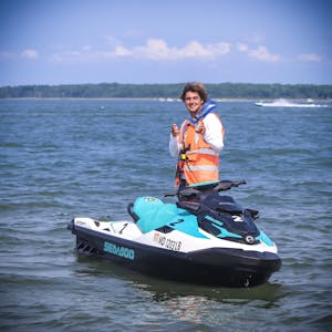 a man riding a jetski and patrolling the water