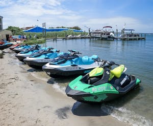 jetskis sitting on a beach in ocean city md