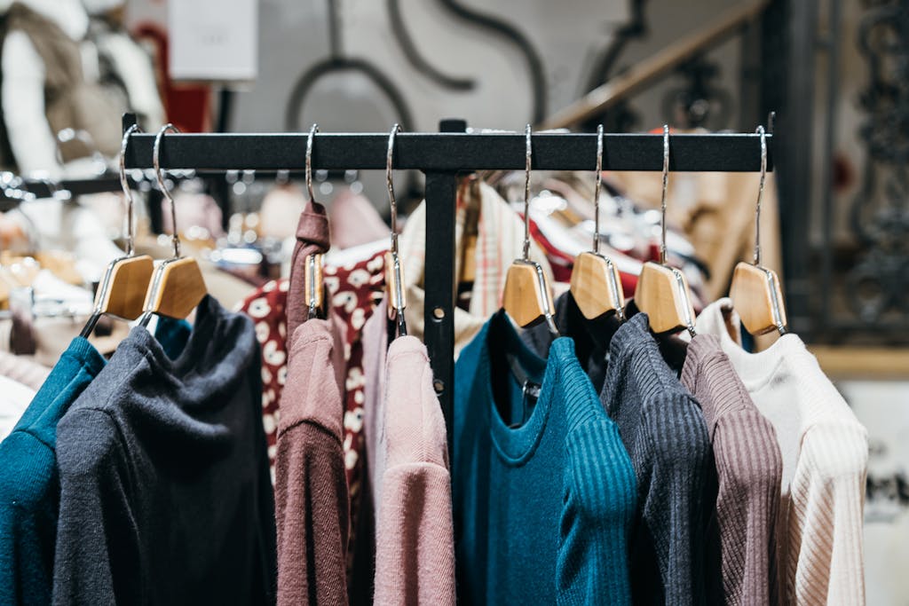 Assorted trendy clothes hanging on hangers