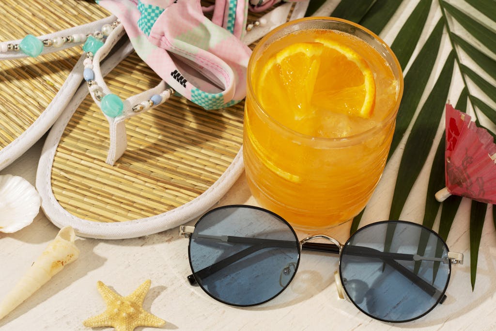 Summer beach necessities with a refreshing cocktail