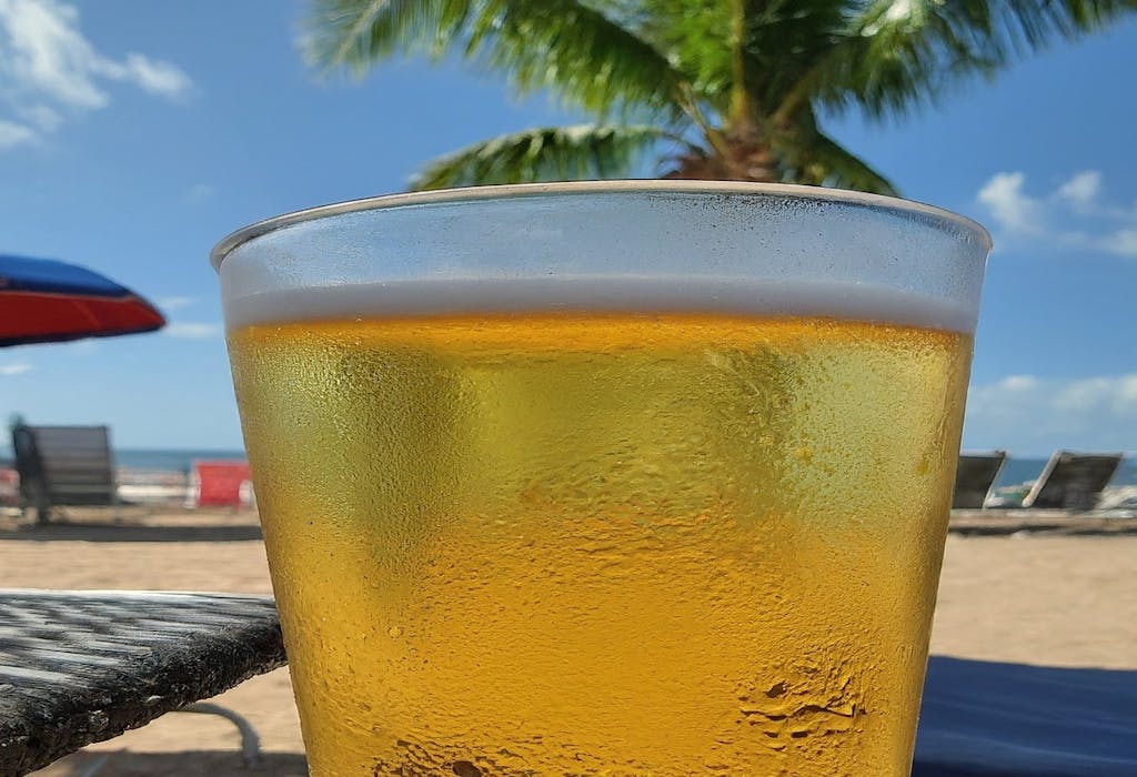 A cold beer served in a beach bar