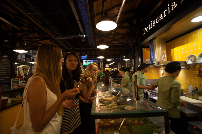 Friends in a food market in Lisbon