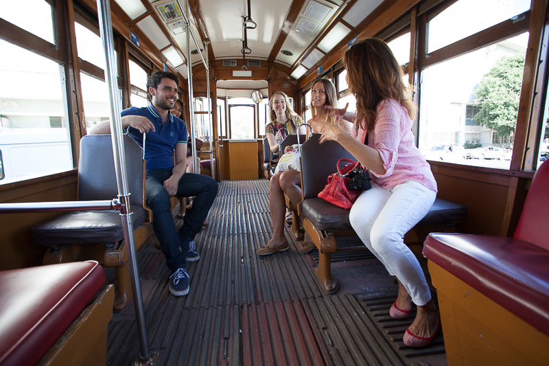 Tour guide explaining in a tram in Lisbon