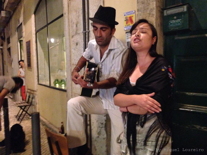 Couple singing fado in streets of Lisbon