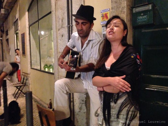 Couple singing fado in streets of Lisbon