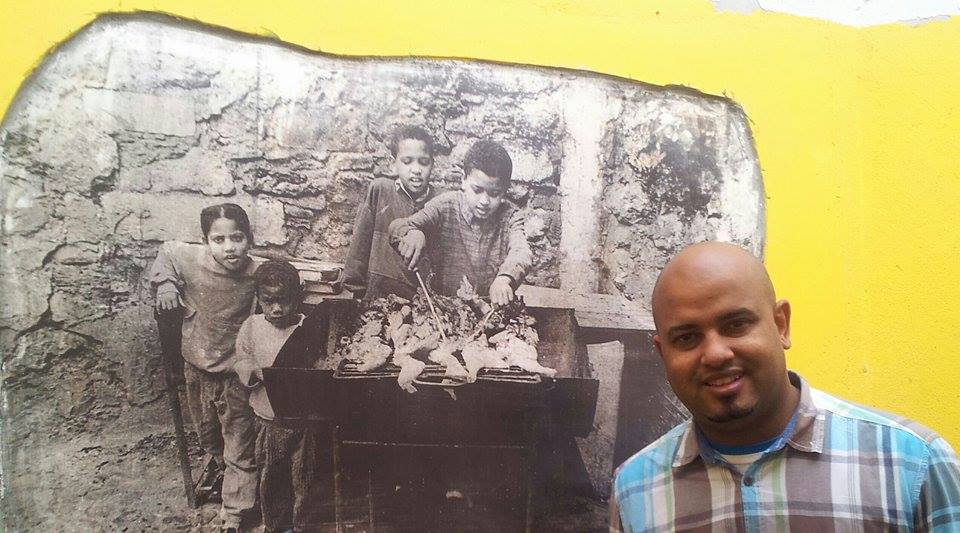 Man posing in front of a painting