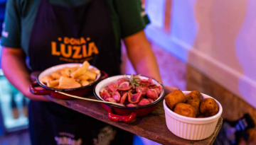 a person sitting at a table with a plate of food