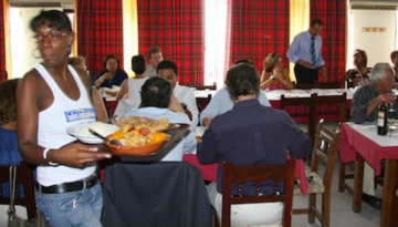 a group of people eating food at a restaurant