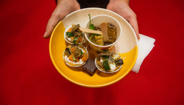 a person holding a bowl of food