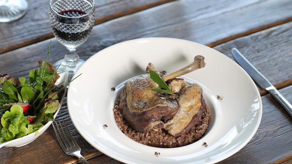 a plate of Portuguese food and a glass of wine