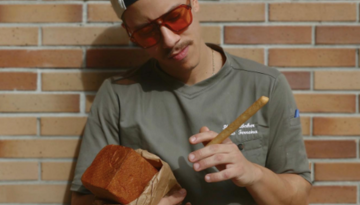 a person standing in front of a brick building