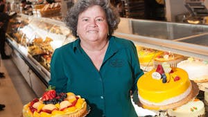 Betty Porto, who co-owns Porto's Bakery and Cafe with her family, holds up two cakes at their Downey location, on Wednesday, February 15, 2017. The family is opening a fourth location in Buena Park on March 1. (Photo by Nick Agro, Orange County Register/SCNG)