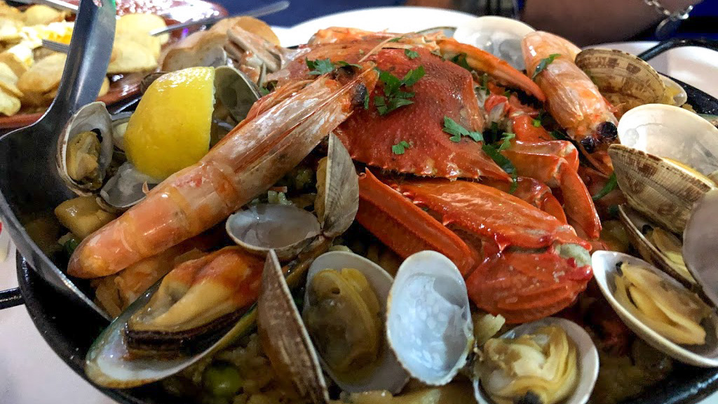 a plate of Portuguese food and drinks in Australia - clams ameijoas with stew