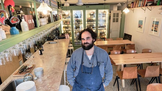 a man sitting at a table in a restaurant