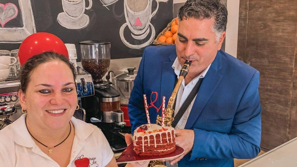 a man cutting a cake