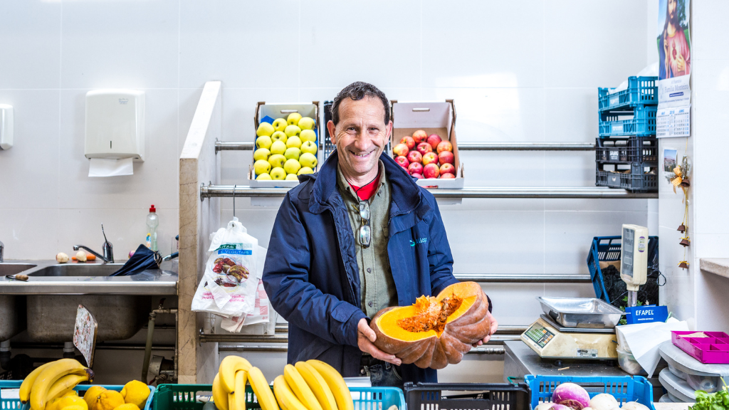 a person sitting at a table with a bunch of bananas