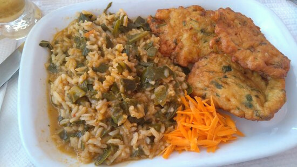 a plate of food with rice meat and vegetables