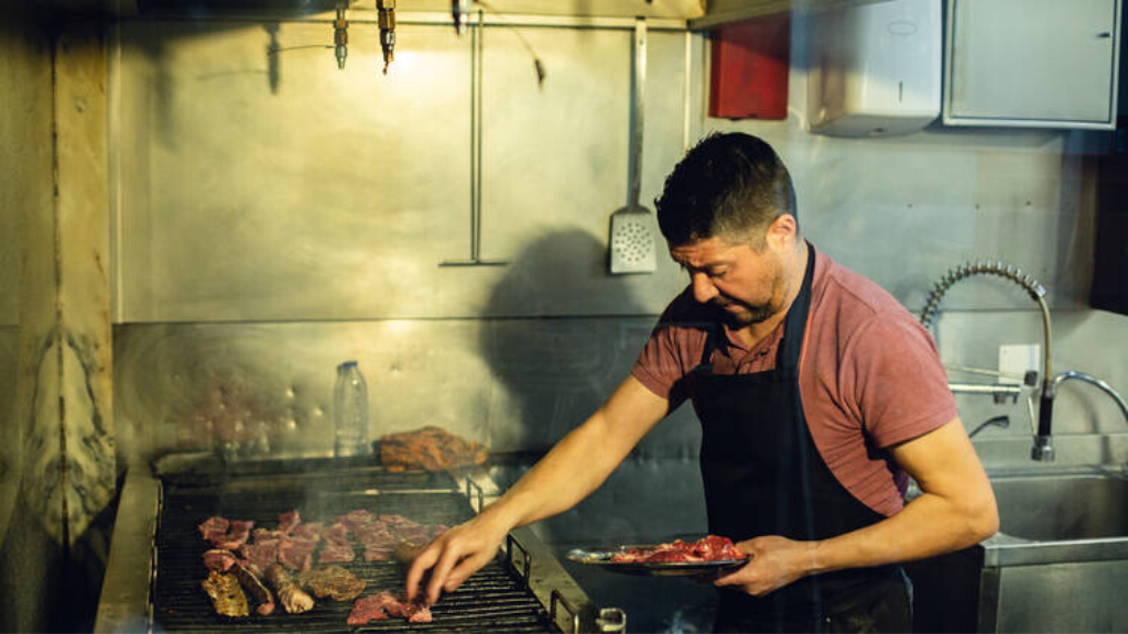 a man cooking in a kitchen preparing food