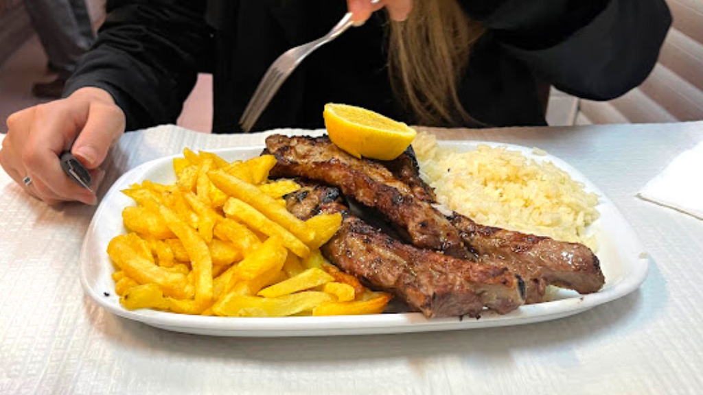 a woman sitting at a table with a plate of food