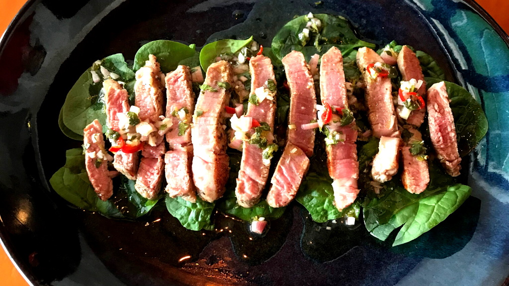 a pan filled with meat and vegetables