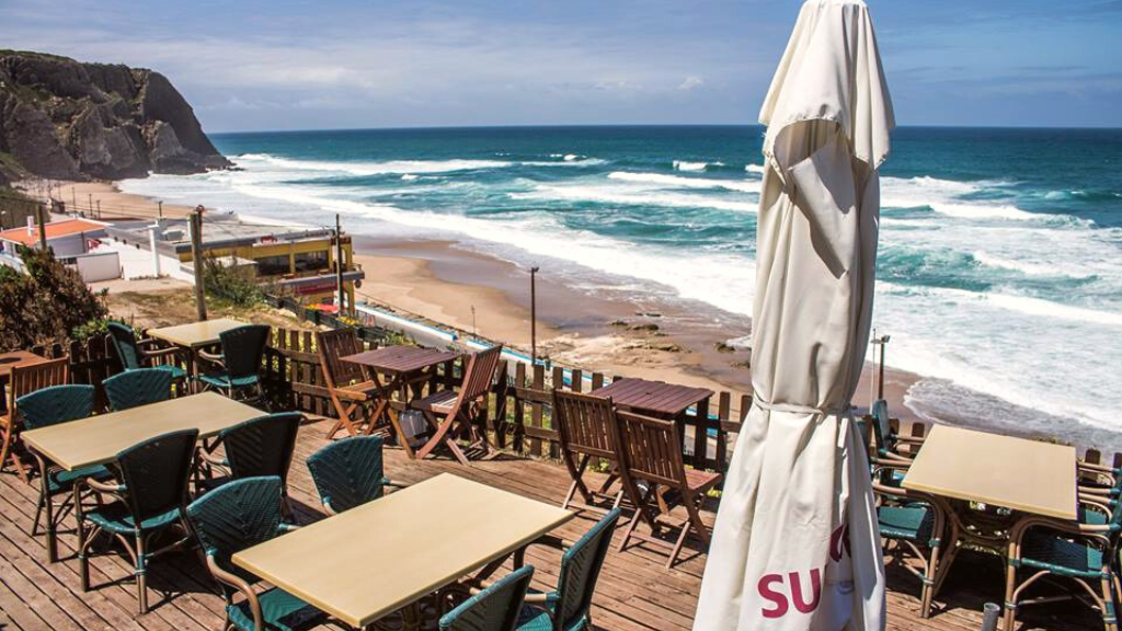 a group of lawn chairs sitting on top of a beach