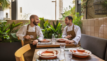 a group of people sitting at a table in a restaurant