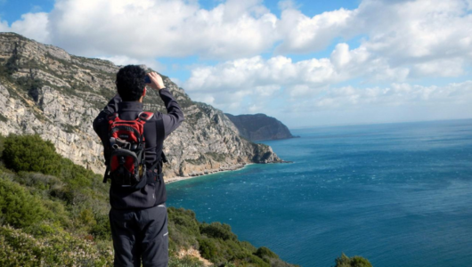 a man standing on a rocky hill