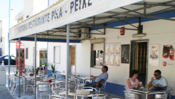 a group of people sitting at a table in a restaurant