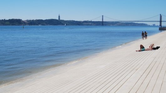 a group of people on a beach near a body of water