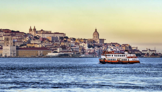 a large body of water with a city in the background