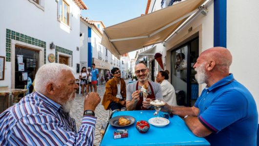 a group of people standing around a table