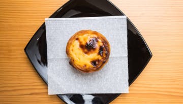 a doughnut sitting on top of a wooden table
