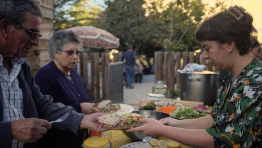 a group of people sitting at a table eating food