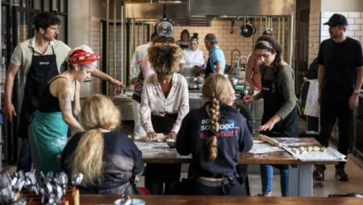 a group of people standing around a table