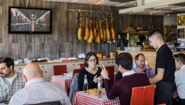 a group of people sitting at a table in a restaurant