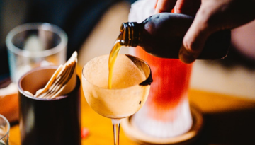 a close up of a person drinking from a cup