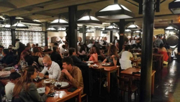 a group of people sitting at a table in a restaurant