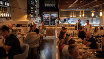 a group of people sitting at a table in a restaurant