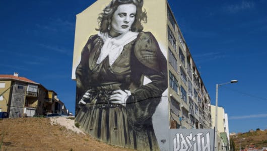 a mural of Amália Rodrigues in a building
