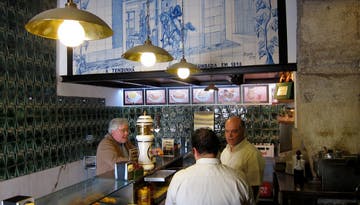 a group of people talking at the counter