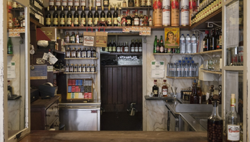 behind the counter of Sem Rival: bottles of ginginha, water, tobacco.