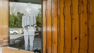a wooden wall and glass with image of a policeman