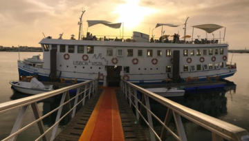 a boat is docked next to a body of water