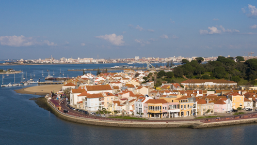 a large body of water with a city in the background