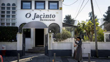 a person walking down a street in front of a building